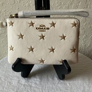 Coach: White Wristlet- Gold Star Embellishments- Gold Tone